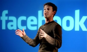 Facebook founder Mark Zuckerberg in front of Facebook Logo